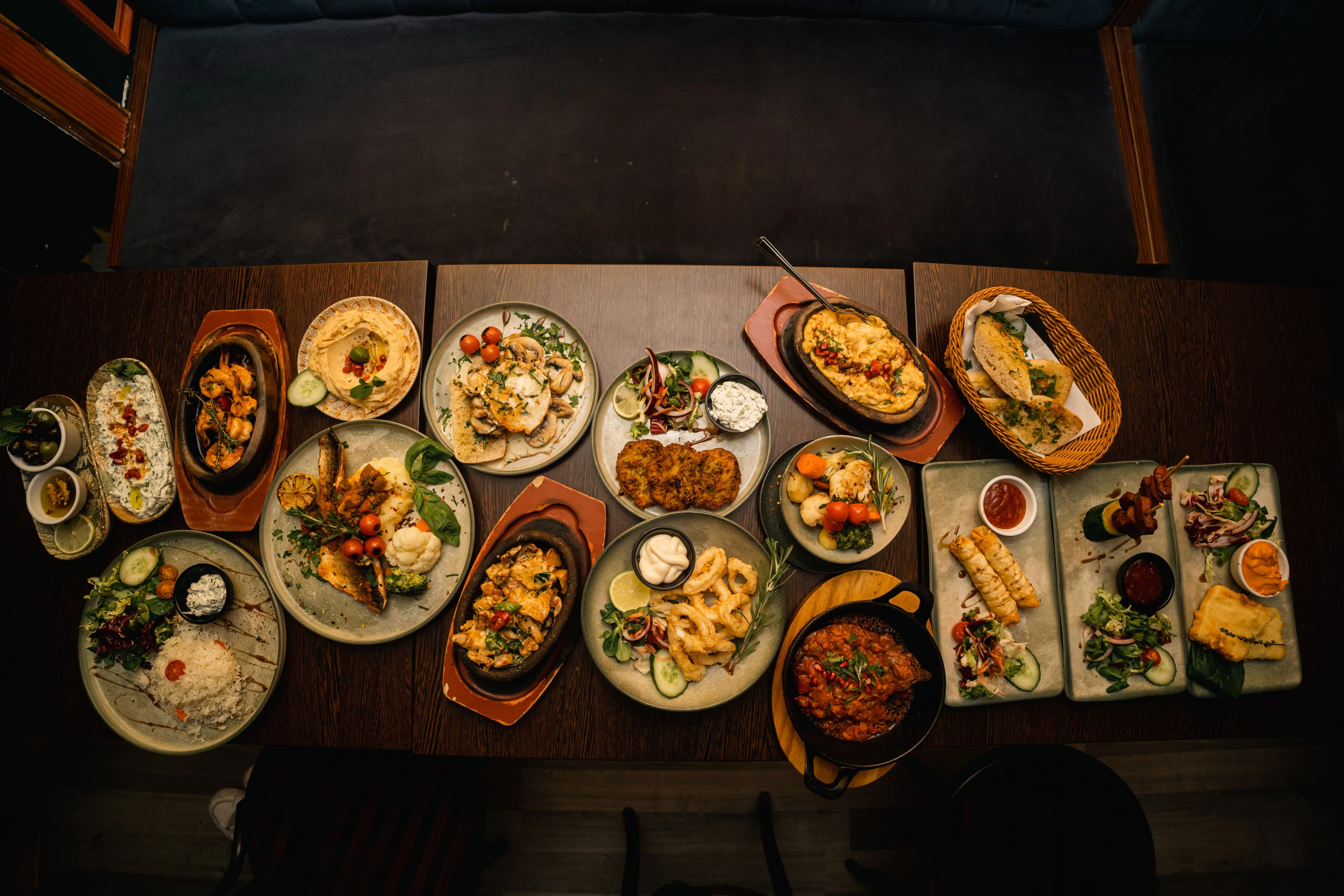 Assorted Spanish tapas including croquetas, patatas bravas, and other traditional dishes